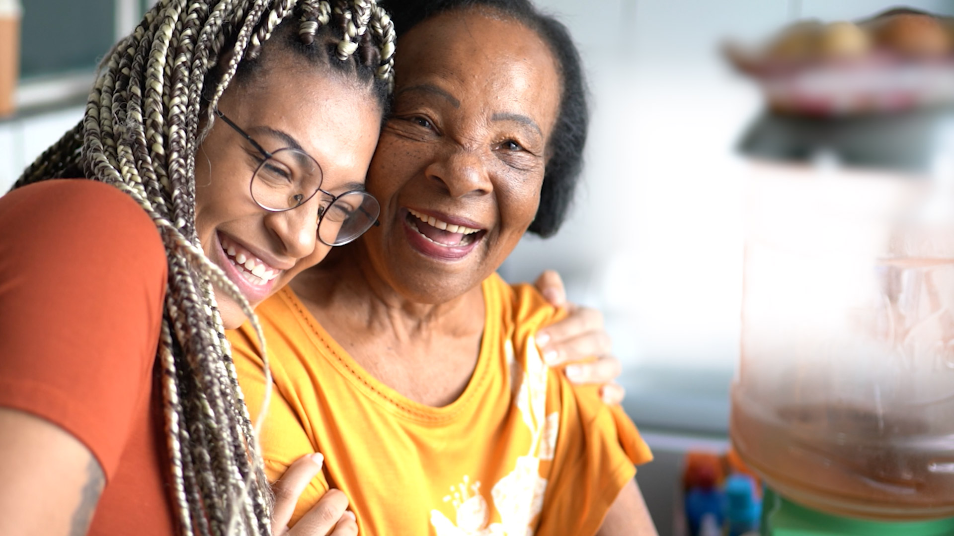 Family caregiver helping elderly loved one at home